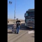 Israeli coloniser puts his baby in danger to block aid to Gaza